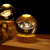 Celeste galaxy crystal lamp glowing on a wood base