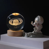Celeste lamp shown in Saturn design variant on wood base