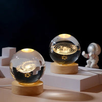 Celeste crystal lamp with hand-etched 3D galaxy design lit up