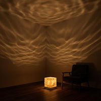 Givre crystal lamp glowing on a dark table against a walnut wood backdrop
